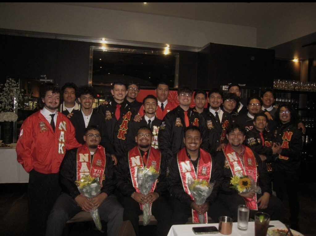 Perez (centered) poses with 2025 NAK graduates.